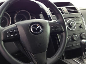 Image used under a Collective Commons License from https://www.peakpx.com/445656/black-mazda-multi-function-steering-wheel